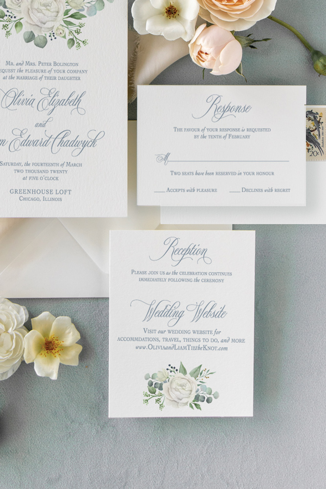 White rose wedding invitation reception card in Chicago with dusty blue background.