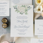 Rose and eucalyptus watercolor wedding invitation at Greenhouse Loft in Chicago with dusty blue ink.