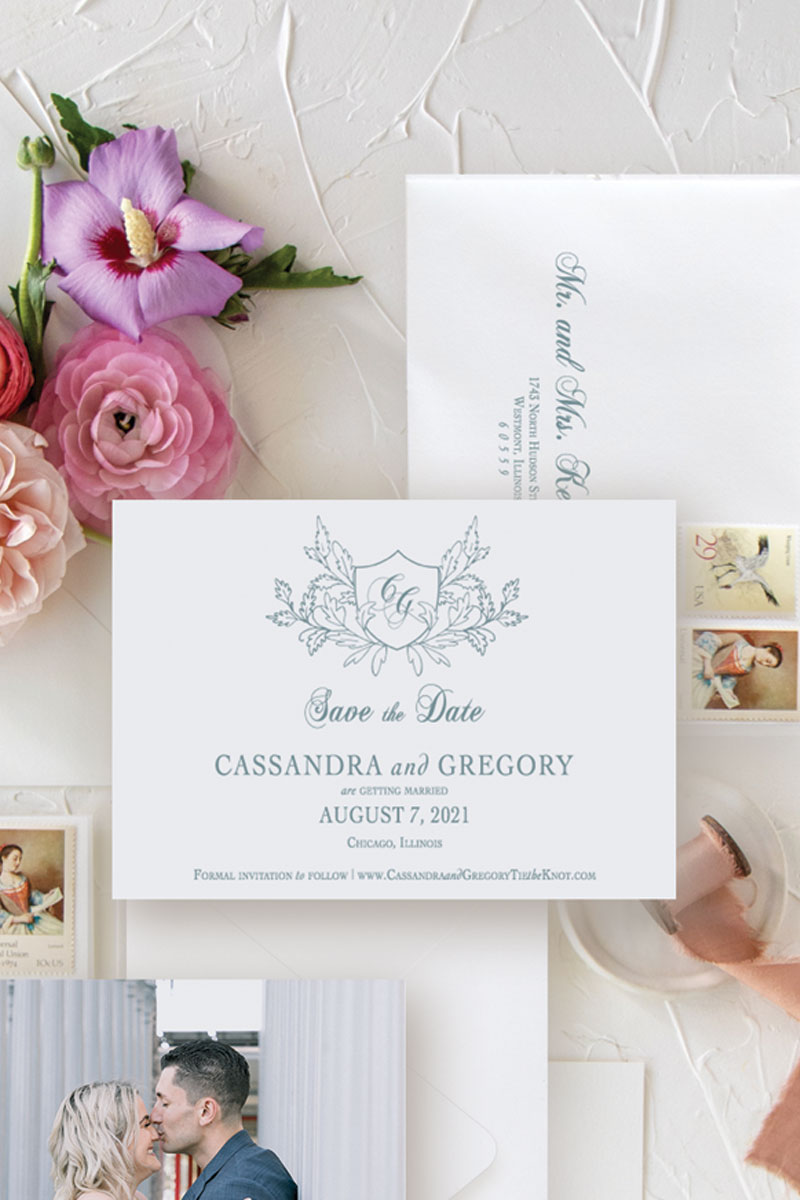 Save the date with wedding crest and engagement photo with colorful wedding flowers and dusty blue ink.